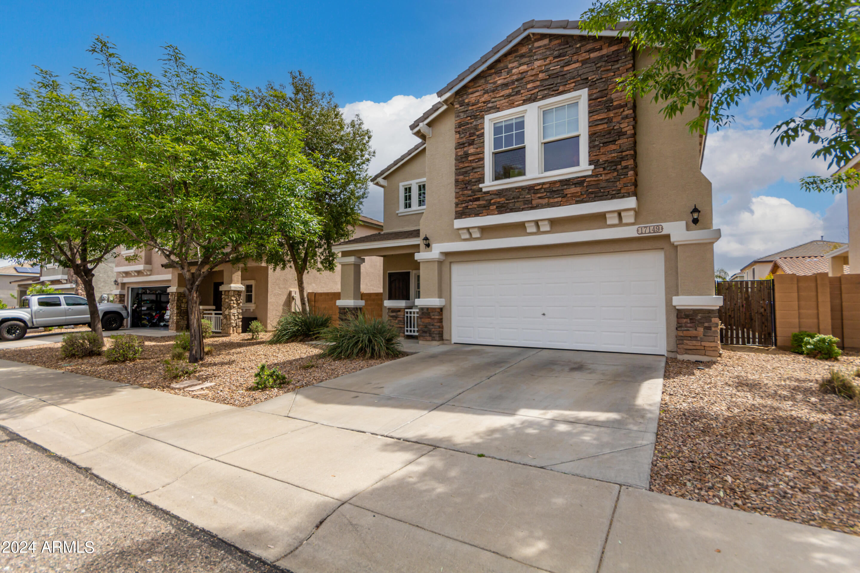 17149 West Rimrock Street Surprise, AZ 85388 - Photo 3 of 46 a front view of a house with a yard