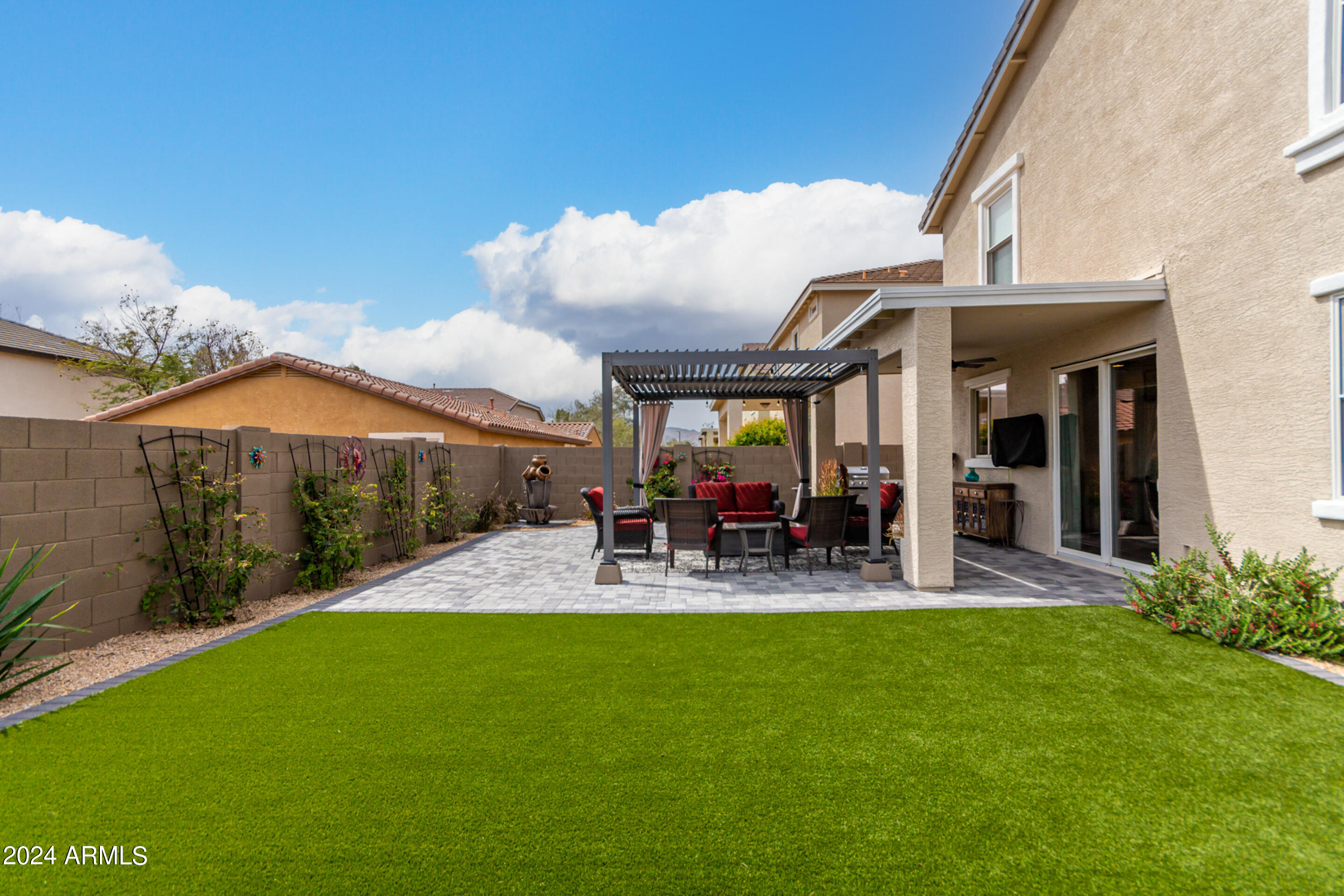 17149 West Rimrock Street Surprise, AZ 85388 - Photo 36 of 46 a view of a patio with table and chairs under an umbrella