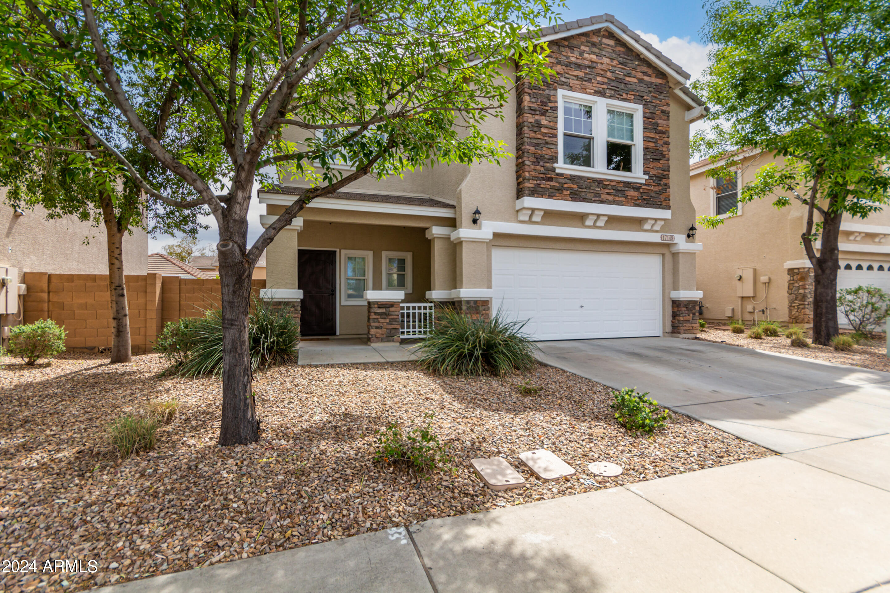 17149 West Rimrock Street Surprise, AZ 85388 - Photo 5 of 46 a front view of a house with a porch