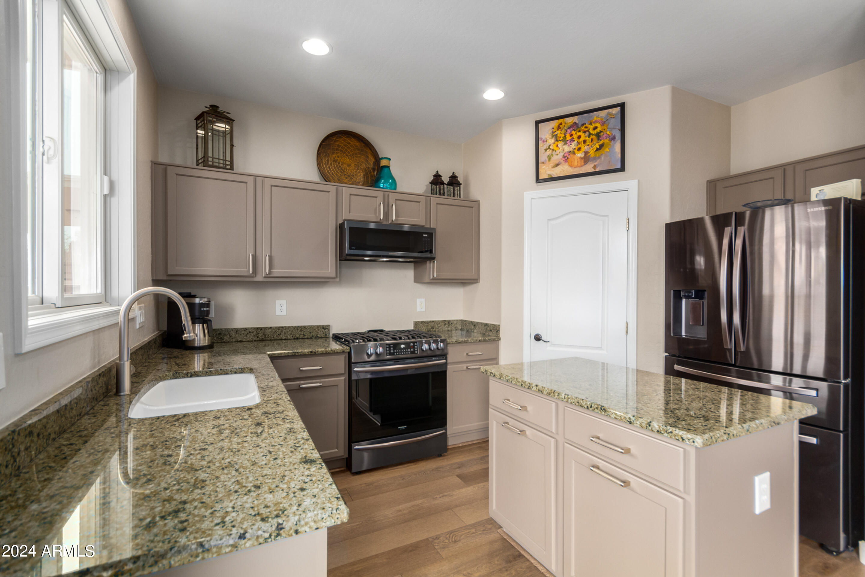 17149 West Rimrock Street Surprise, AZ 85388 - Photo 9 of 46 a kitchen with stainless steel appliances granite countertop a stove sink and refrigerator