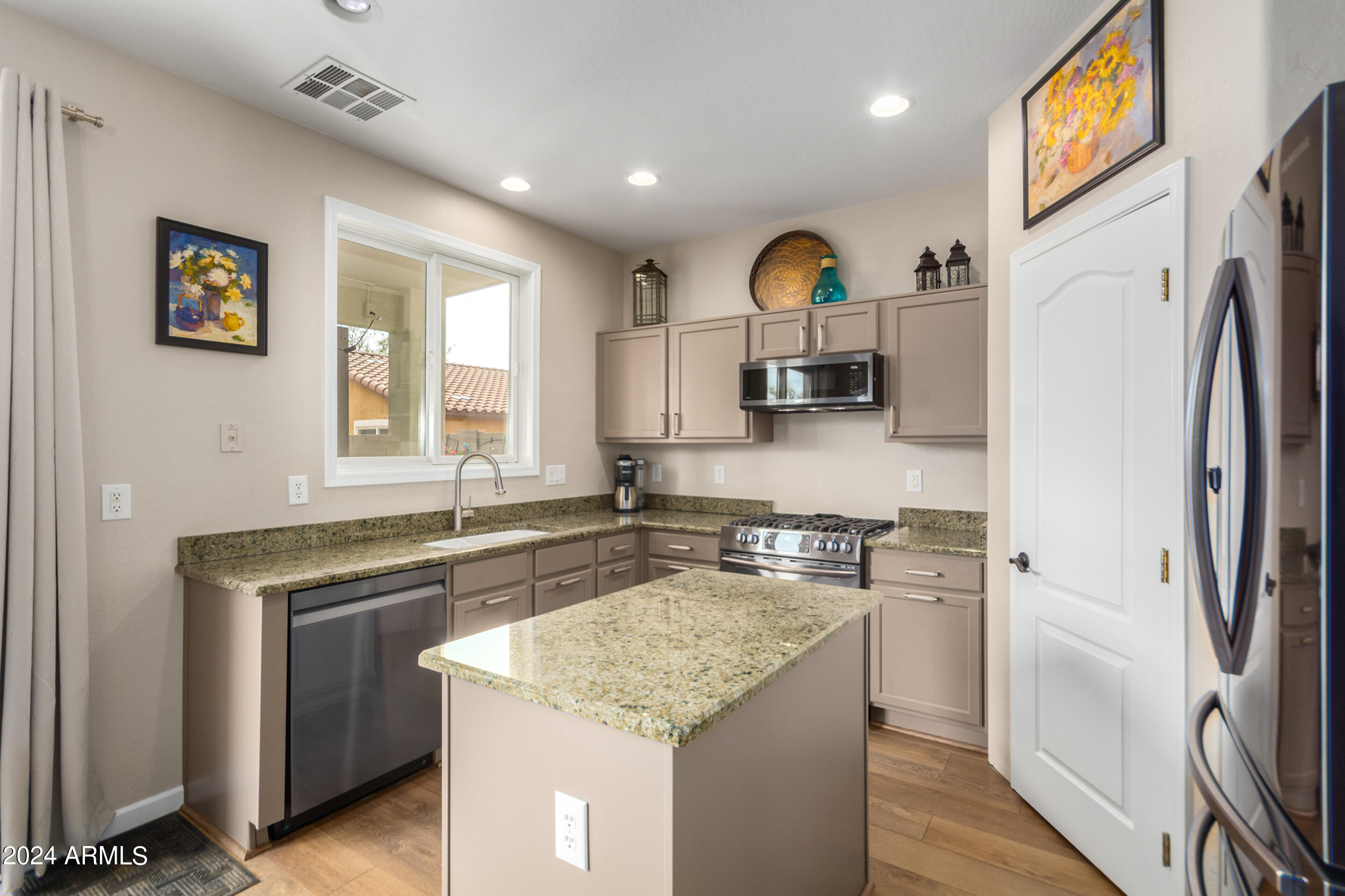 17149 West Rimrock Street Surprise, AZ 85388 - Photo 10 of 46 a kitchen with a sink stove and refrigerator