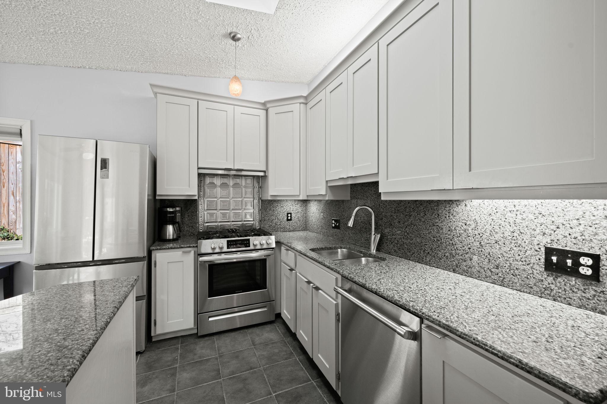 2904 Russell Road Alexandria, VA 22305 - Photo 12 of 52 a kitchen with granite countertop a sink stainless steel appliances and cabinets