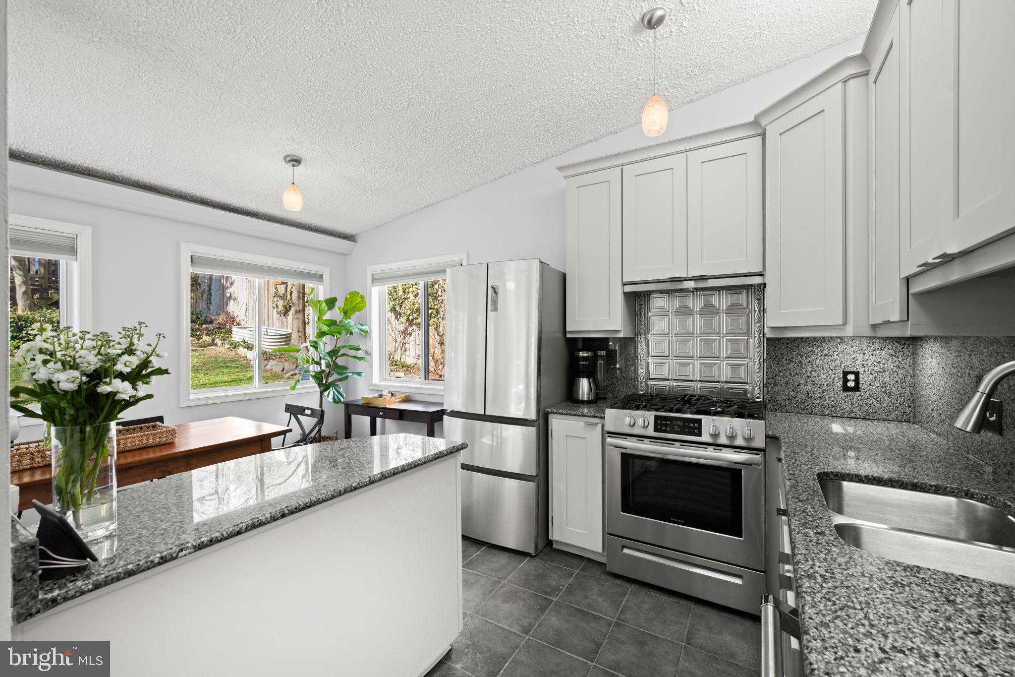 2904 Russell Road Alexandria, VA 22305 - Photo 13 of 52 a kitchen with granite countertop a sink stainless steel appliances and cabinets