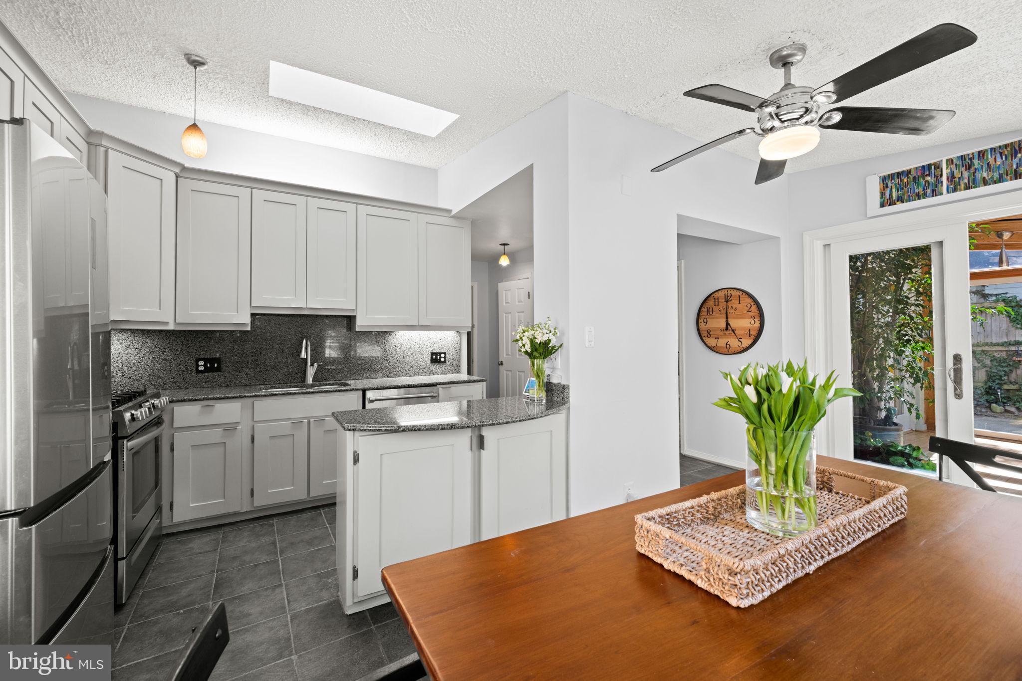 2904 Russell Road Alexandria, VA 22305 - Photo 16 of 52 a kitchen with stainless steel appliances granite countertop a refrigerator a sink dishwasher and white cabinets with wooden floor