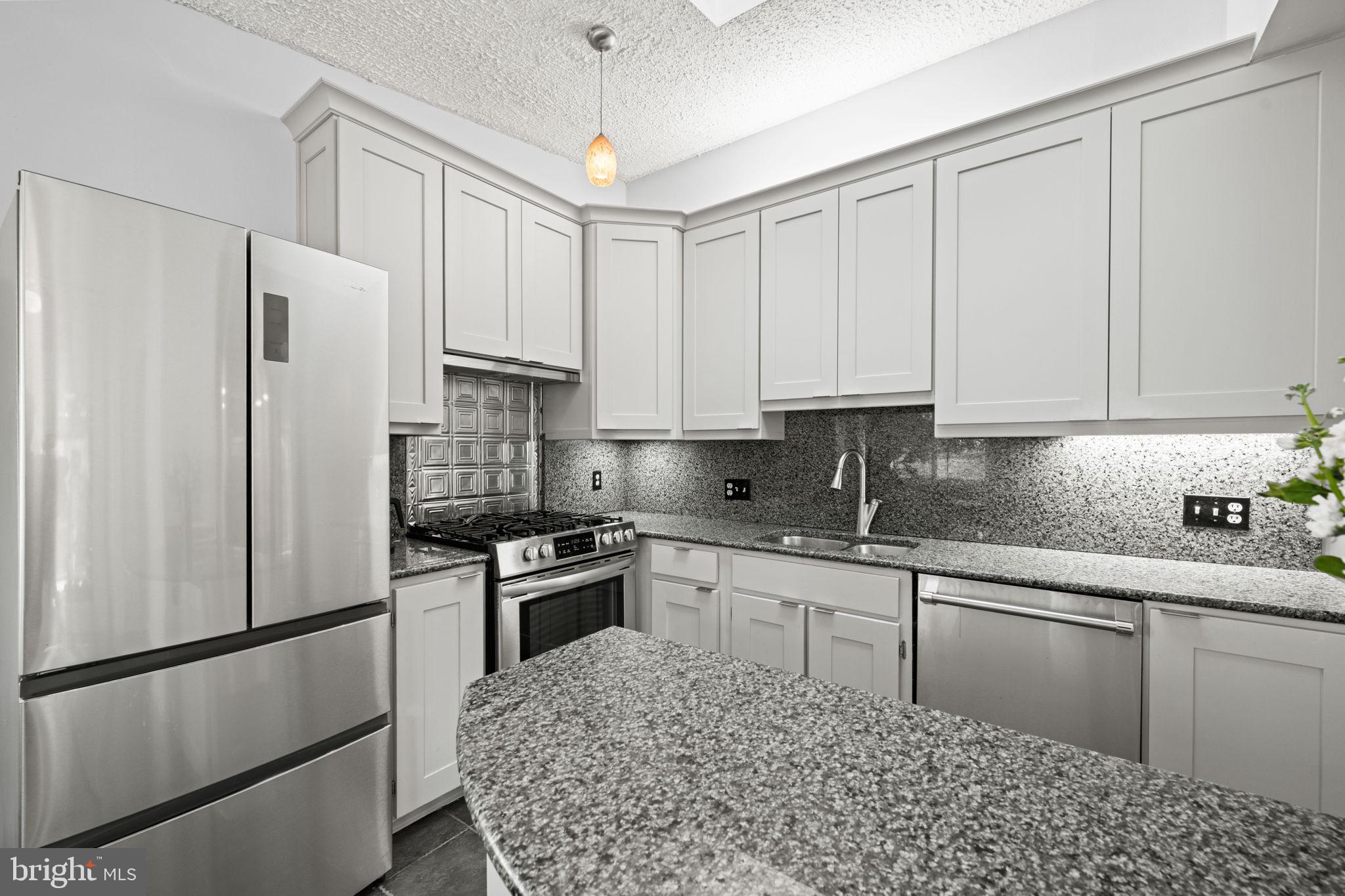 2904 Russell Road Alexandria, VA 22305 - Photo 17 of 52 a kitchen with stainless steel appliances granite countertop a refrigerator sink stove and white cabinets