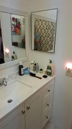 a bathroom with a sink a toilet and a shower curtain