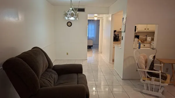 a living room with furniture and a chandelier