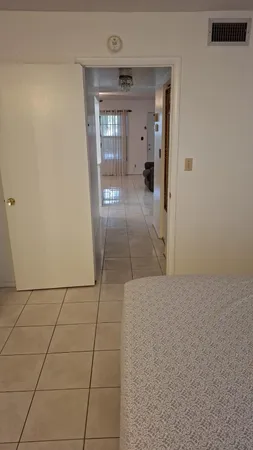a view of hallway with a couch and a window