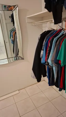 a view of walk in closet with clothes and shoes