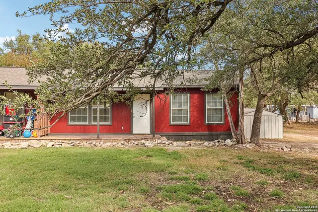 a large tree in front of a house
