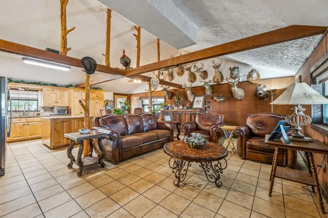 a living room with furniture and a floor to ceiling window