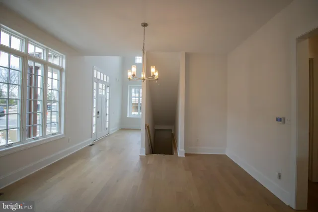 a view of a room with windows and chandelier