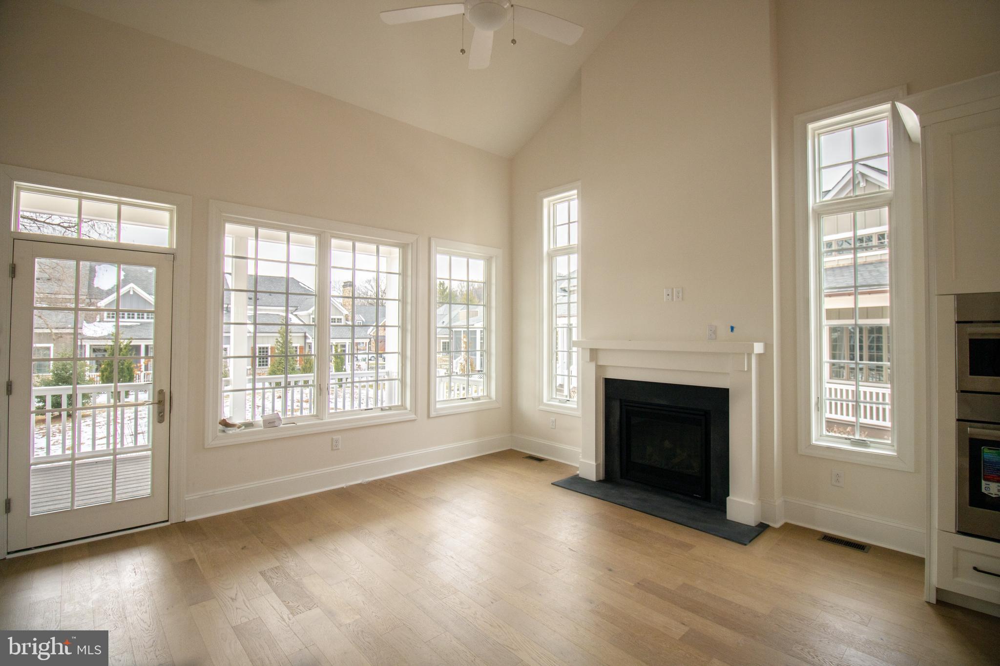 1106 Invermere Road Wilmington, DE 19803 - Photo 5 of 11 wooden floor fireplace and windows in an empty room