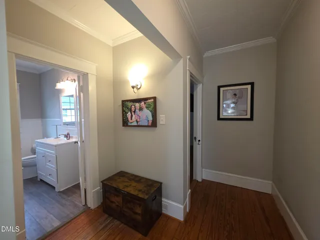 a view of room with wooden floor and furniture