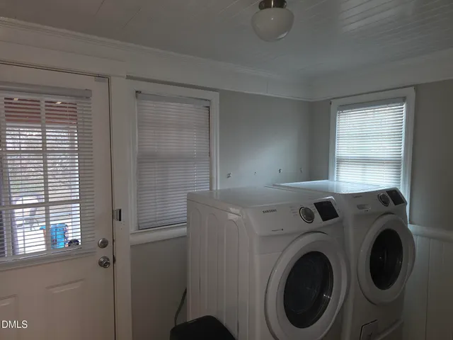 a view of storage and utility room with washer and dryer