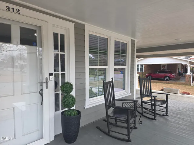 a view of a dining room with furniture and a potted plant