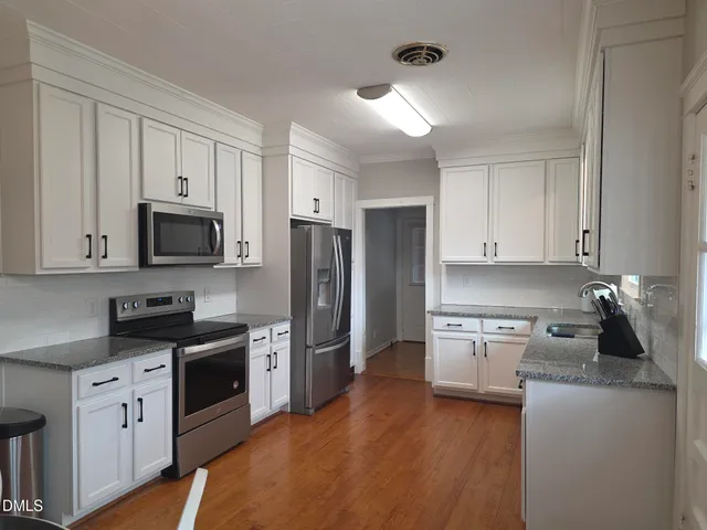 a kitchen with a refrigerator stove and microwave