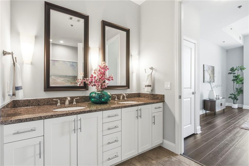 270 17th Street Northwest, Unit 4306 Atlanta, GA 30363 - Photo 26 of 37 a bathroom with a granite countertop sink and a mirror
