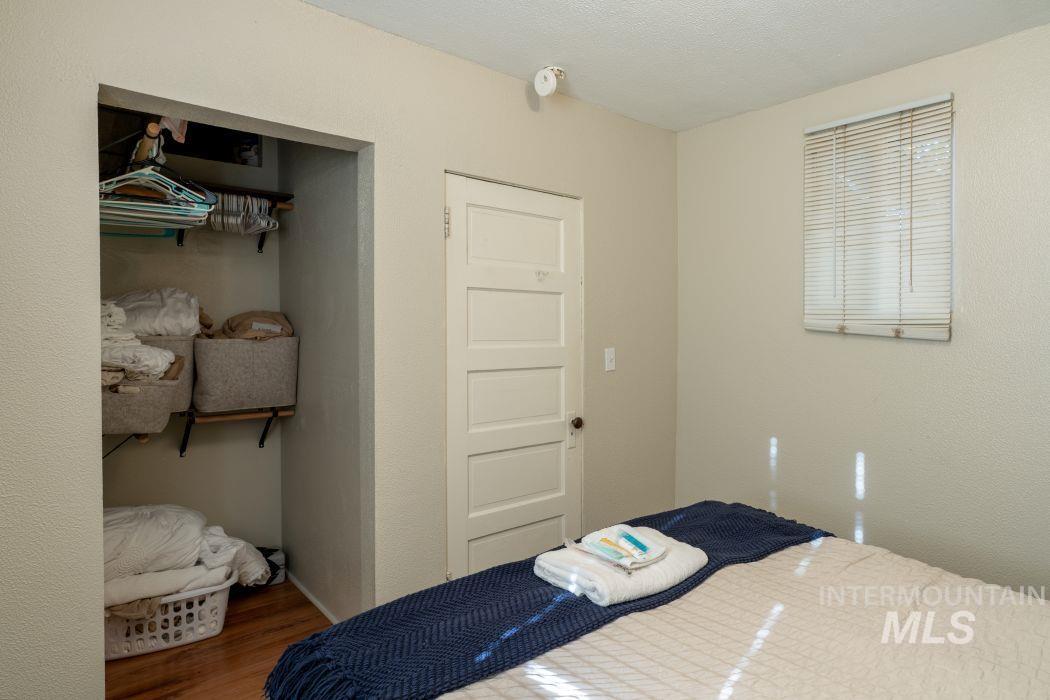 112 South Asbury Street Moscow, ID 83843 - Photo 11 of 26 Bedroom with wood finished floors, a textured ceiling, a closet, and a textured wall