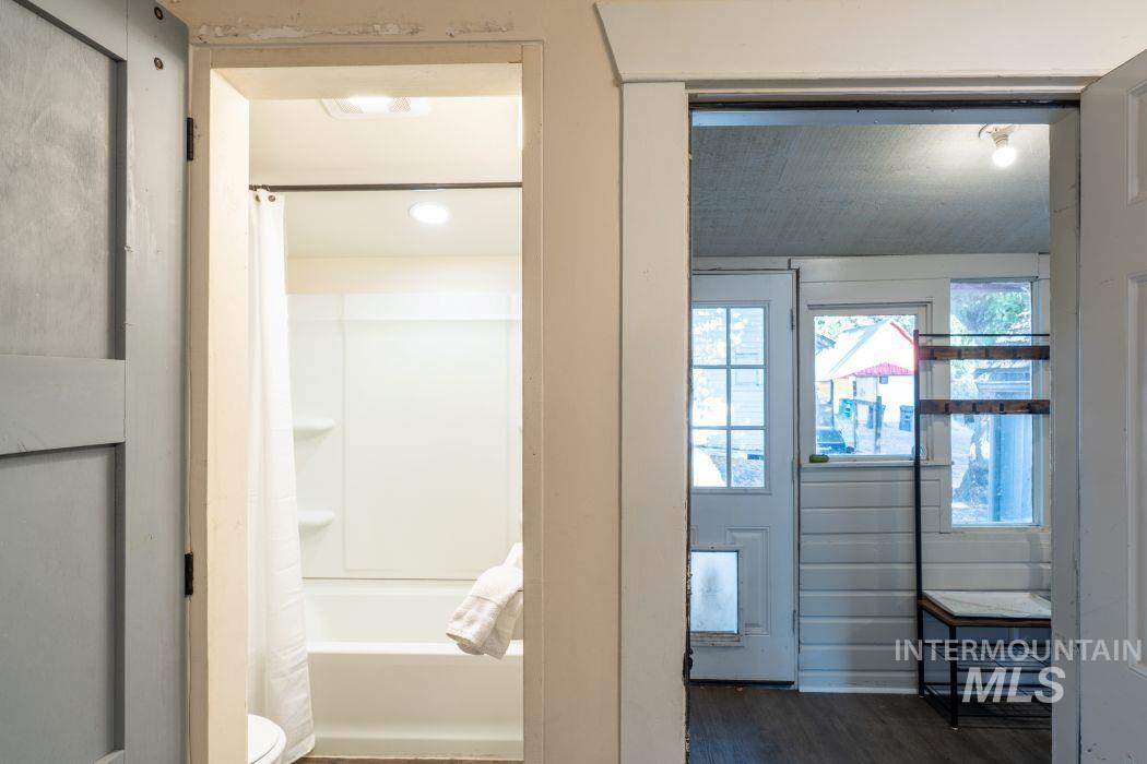 112 South Asbury Street Moscow, ID 83843 - Photo 15 of 26 Full bathroom with dark wood-style flooring and shower / bathtub combination with curtain