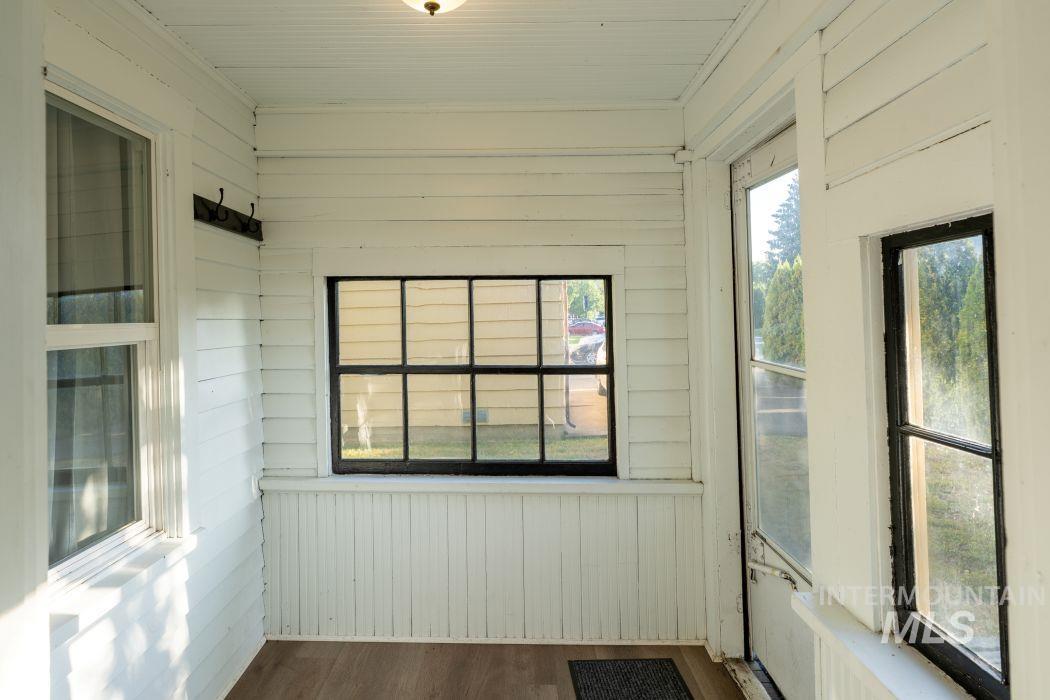112 South Asbury Street Moscow, ID 83843 - Photo 19 of 26 Unfurnished sunroom featuring wood walls and wood finished floors