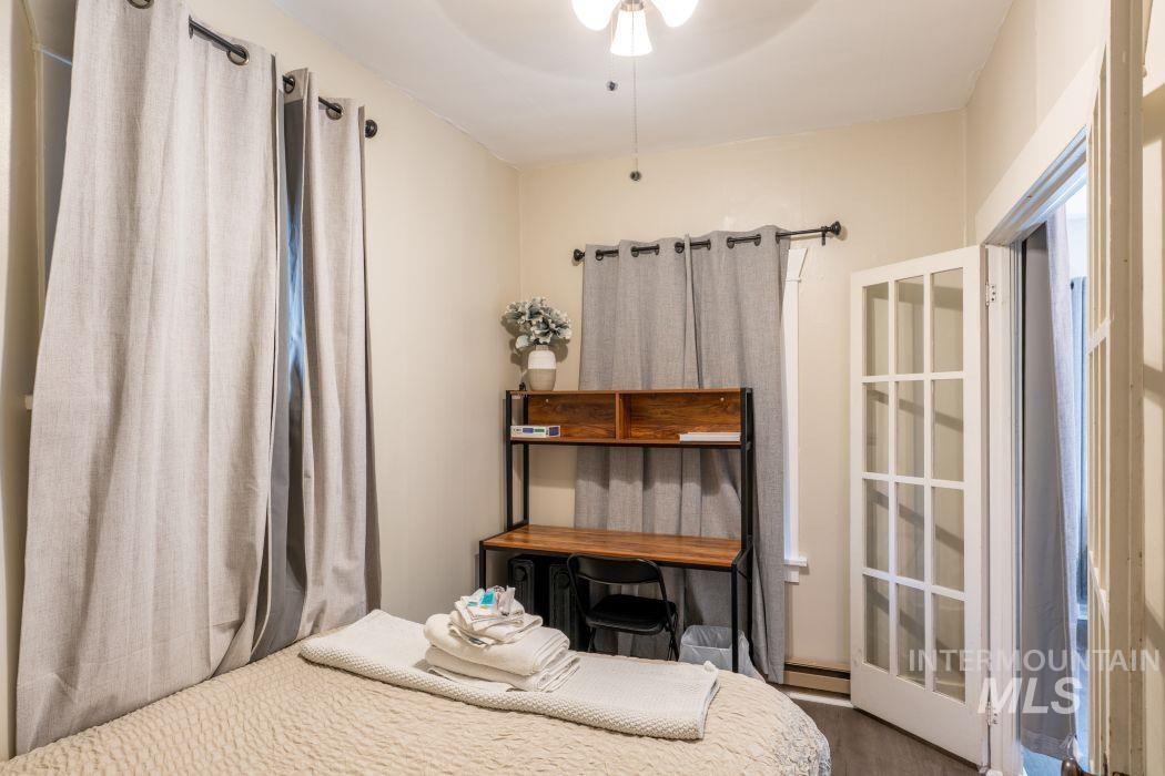 112 South Asbury Street Moscow, ID 83843 - Photo 9 of 26 Bedroom featuring wood finished floors and baseboard heating