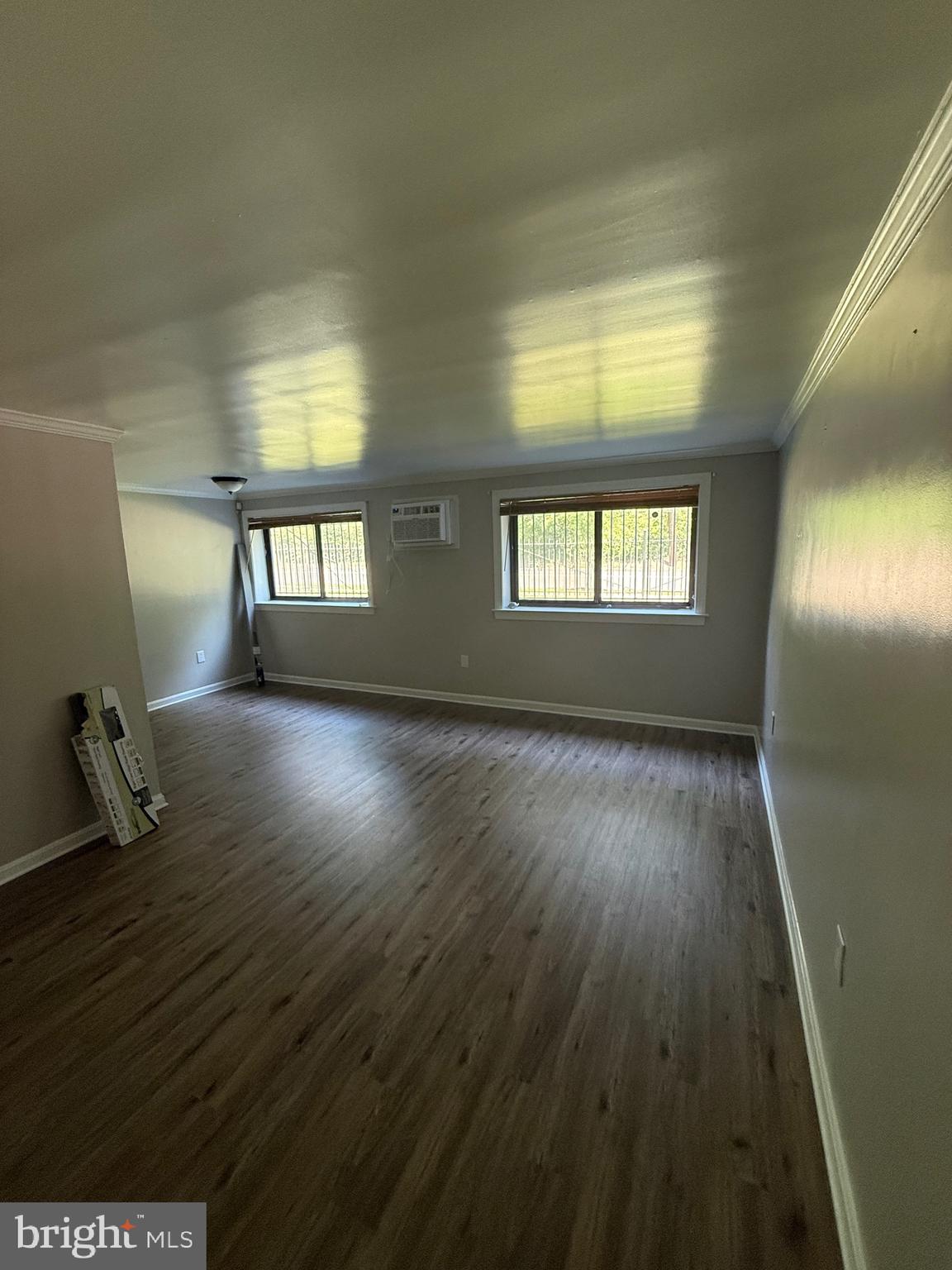 3105 Naylor Road Southeast, Unit 104 Washington, DC 20020 - Photo 11 of 12 a room with wooden floor and windows