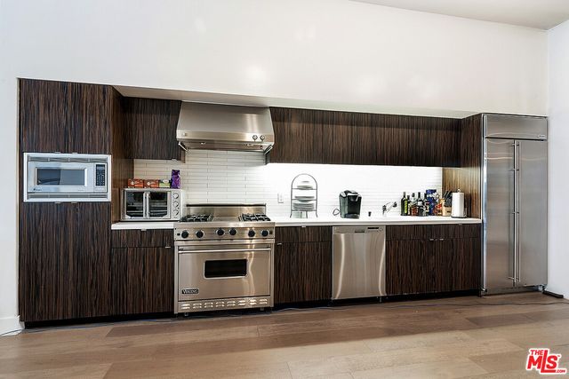 a kitchen with stainless steel appliances a stove and a refrigerator