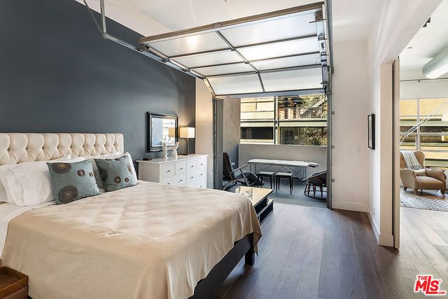 a bedroom with bed and wooden floor