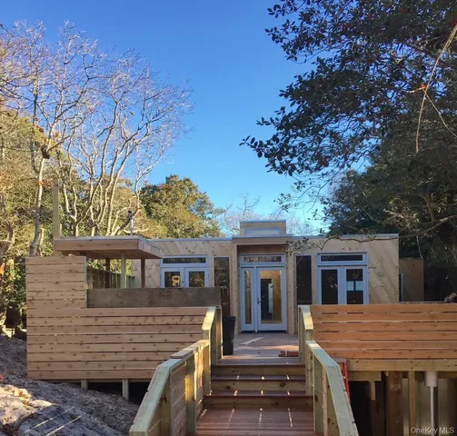 a front view of a house with a tree