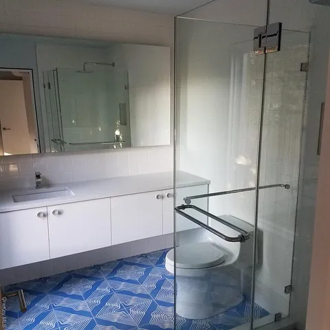 a bathroom with a shower and vanity