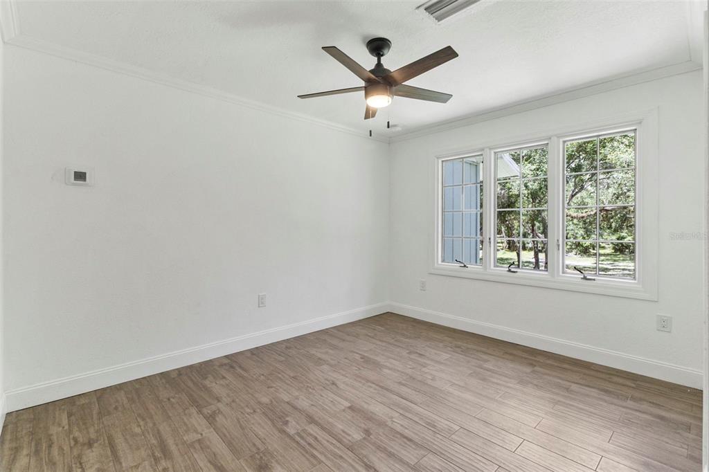 1183 Northwest Girl Scout Road Arcadia, FL 34266 - Photo 16 of 43 wooden floor in an empty room with a window