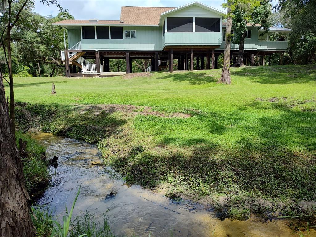 1183 Northwest Girl Scout Road Arcadia, FL 34266 - Photo 32 of 43 a view of an apartment with a garden and trees