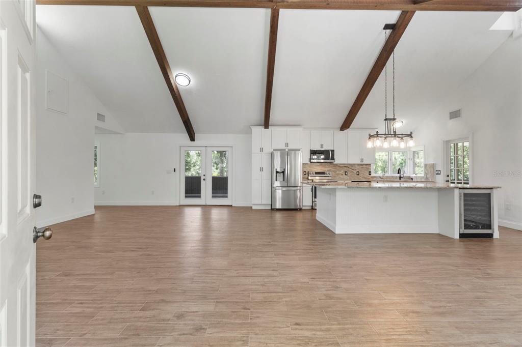 1183 Northwest Girl Scout Road Arcadia, FL 34266 - Photo 8 of 43 a view of a kitchen with kitchen island a stove a sink dishwasher a refrigerator and a fireplace