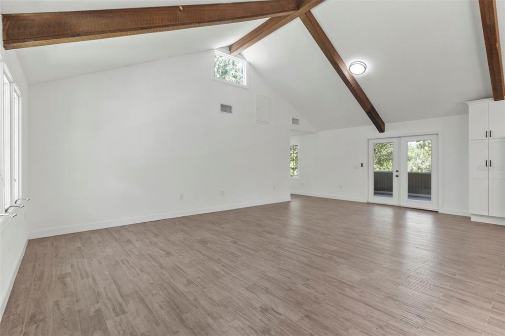 1183 Northwest Girl Scout Road Arcadia, FL 34266 - Photo 10 of 43 a view of an empty room with wooden floor and a window
