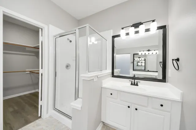 a bathroom with a sink vanity and mirror