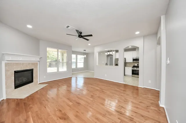 a view of an empty room with window and fire place