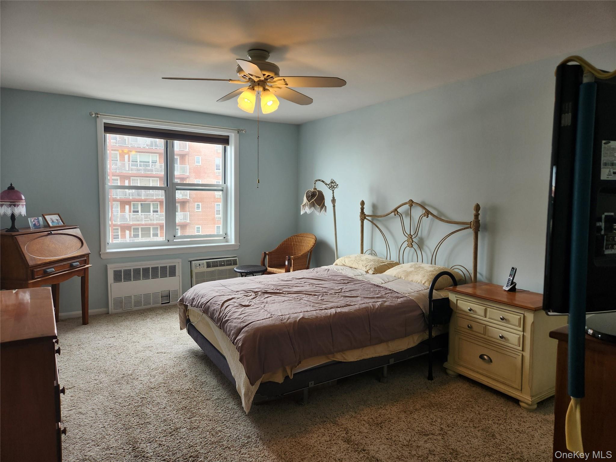 700 Shore Road, Unit 4K Long Beach, NY 11561 - Photo 14 of 32 Bedroom featuring carpet, radiator, and a ceiling fan
