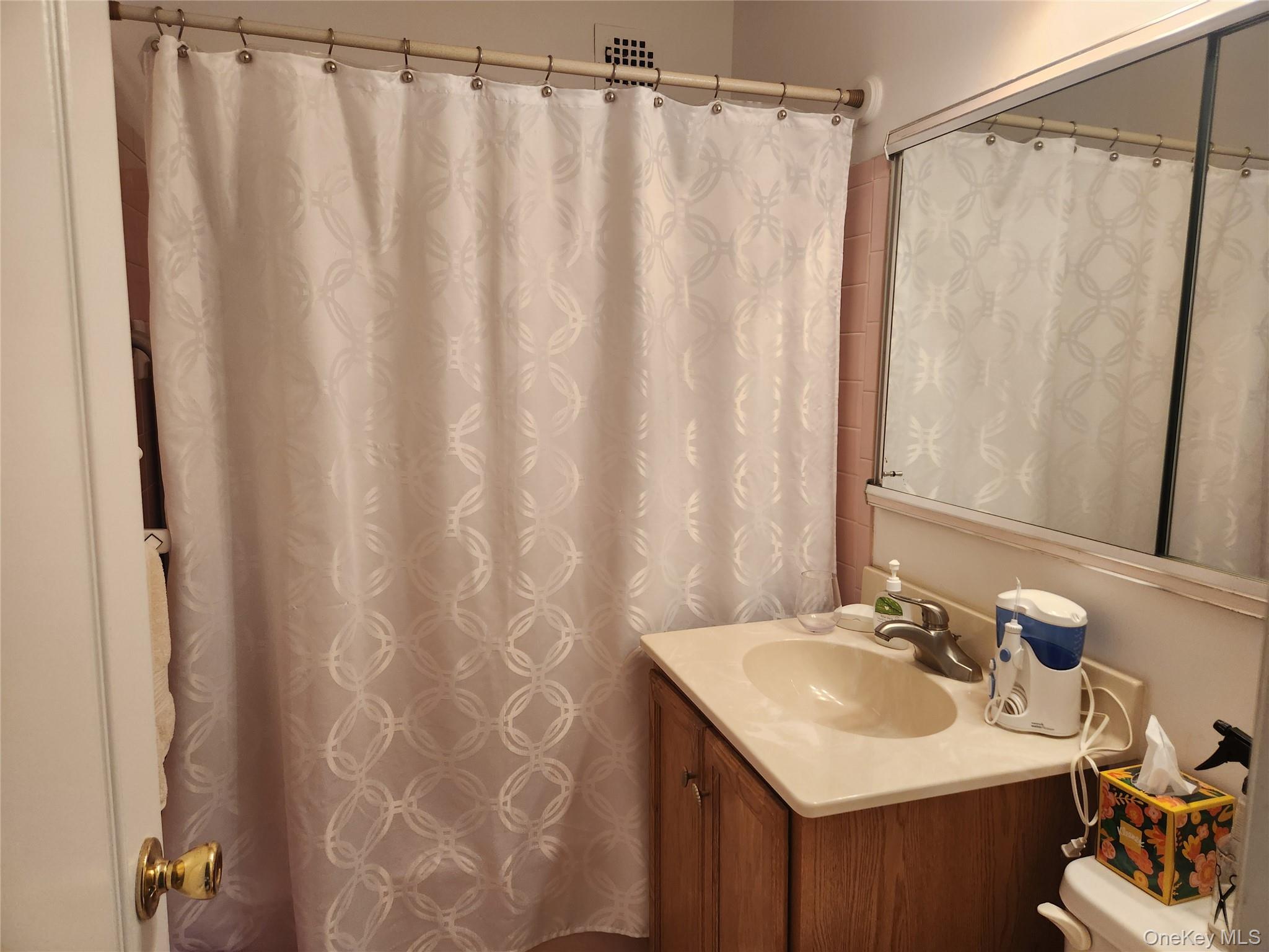 700 Shore Road, Unit 4K Long Beach, NY 11561 - Photo 15 of 32 Full bathroom with vanity and a shower with shower curtain