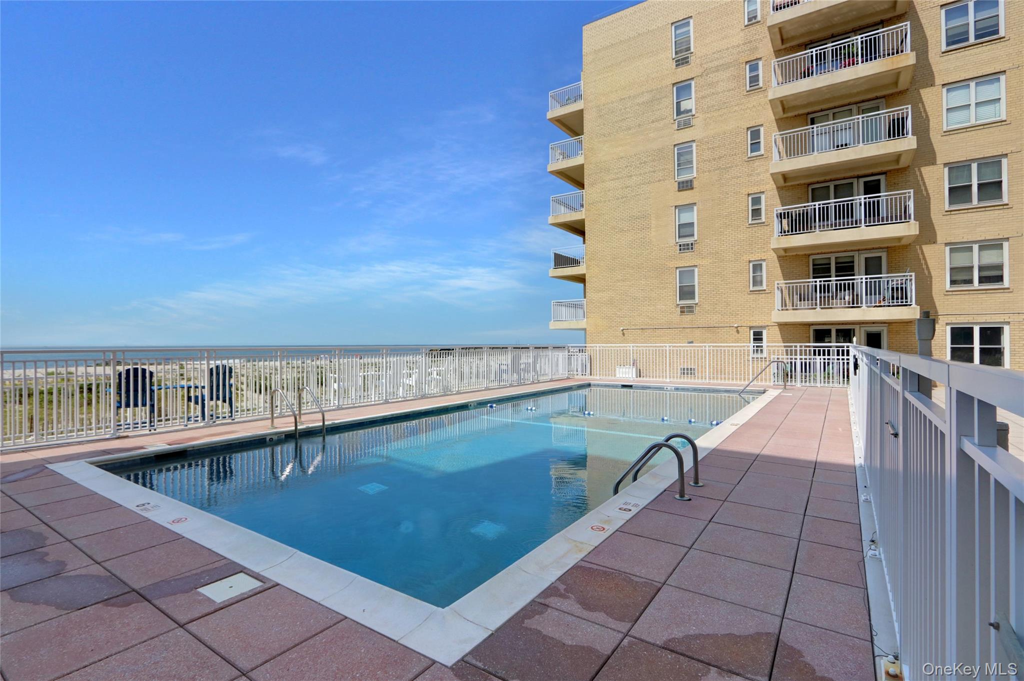 700 Shore Road, Unit 4K Long Beach, NY 11561 - Photo 26 of 32 View of community Solar Heated Salt Water Inground Swimming Pool