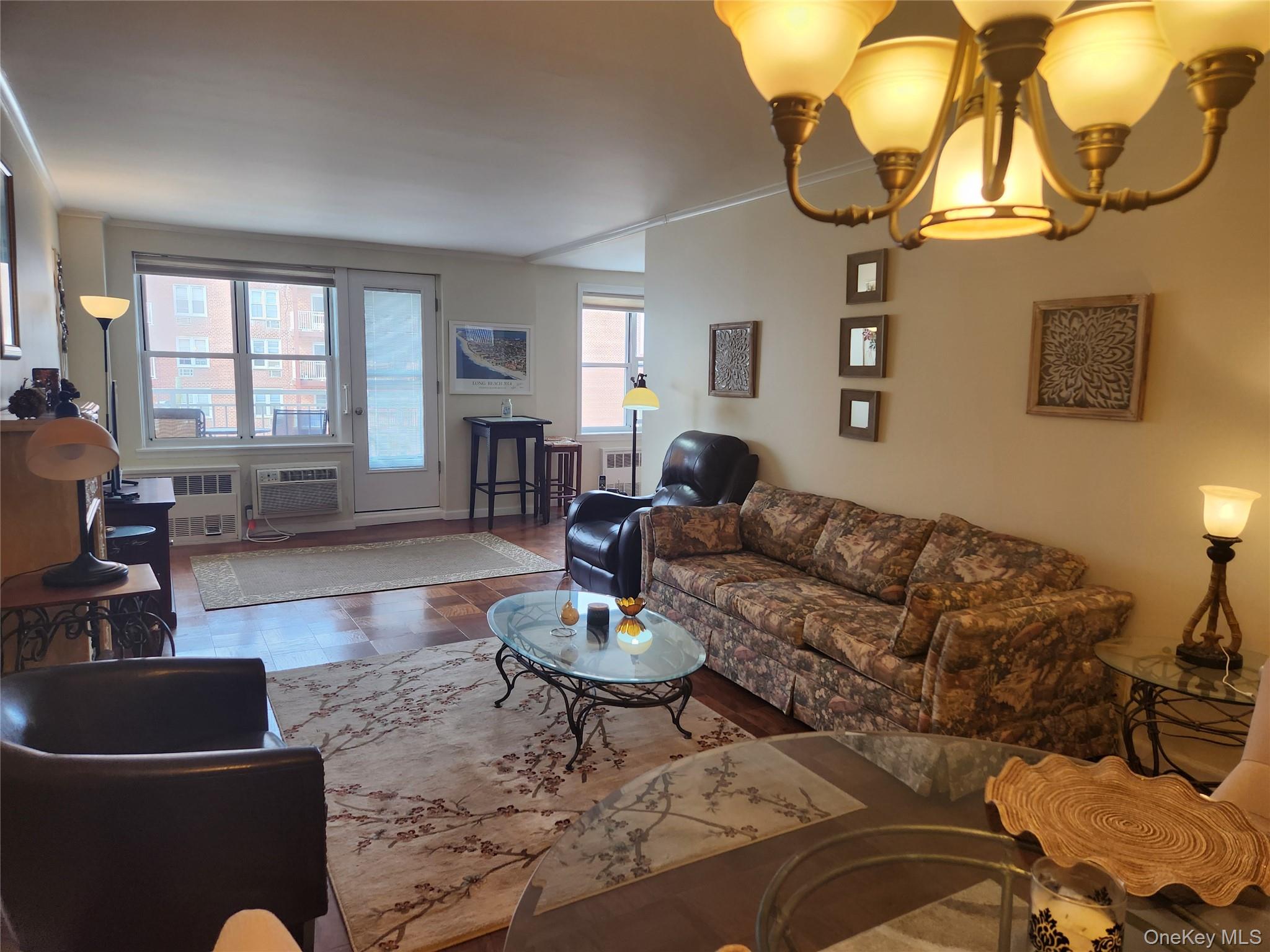 700 Shore Road, Unit 4K Long Beach, NY 11561 - Photo 4 of 32 Living area with a chandelier, radiator, and crown molding