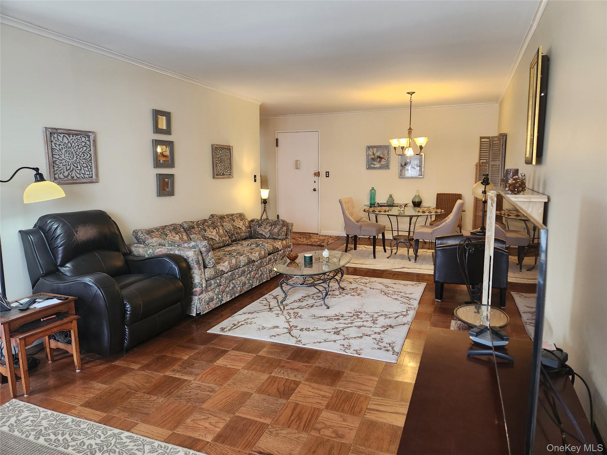 700 Shore Road, Unit 4K Long Beach, NY 11561 - Photo 6 of 32 Living room / Dinning Room with crown molding and a chandelier