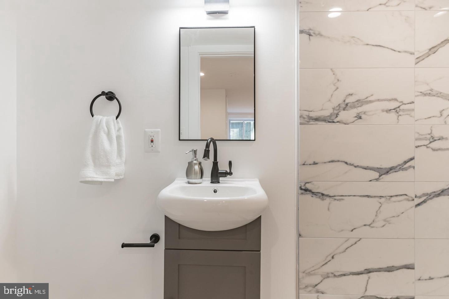 3326 12th Street Southeast Washington, DC 20032 - Photo 11 of 19 a bathroom with a sink and mirror