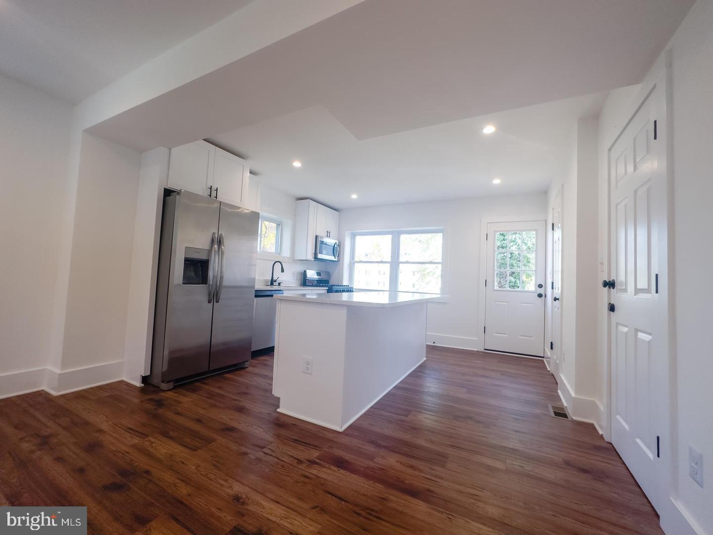 3326 12th Street Southeast Washington, DC 20032 - Photo 5 of 19 a view of a kitchen with wooden floor and a refrigerator
