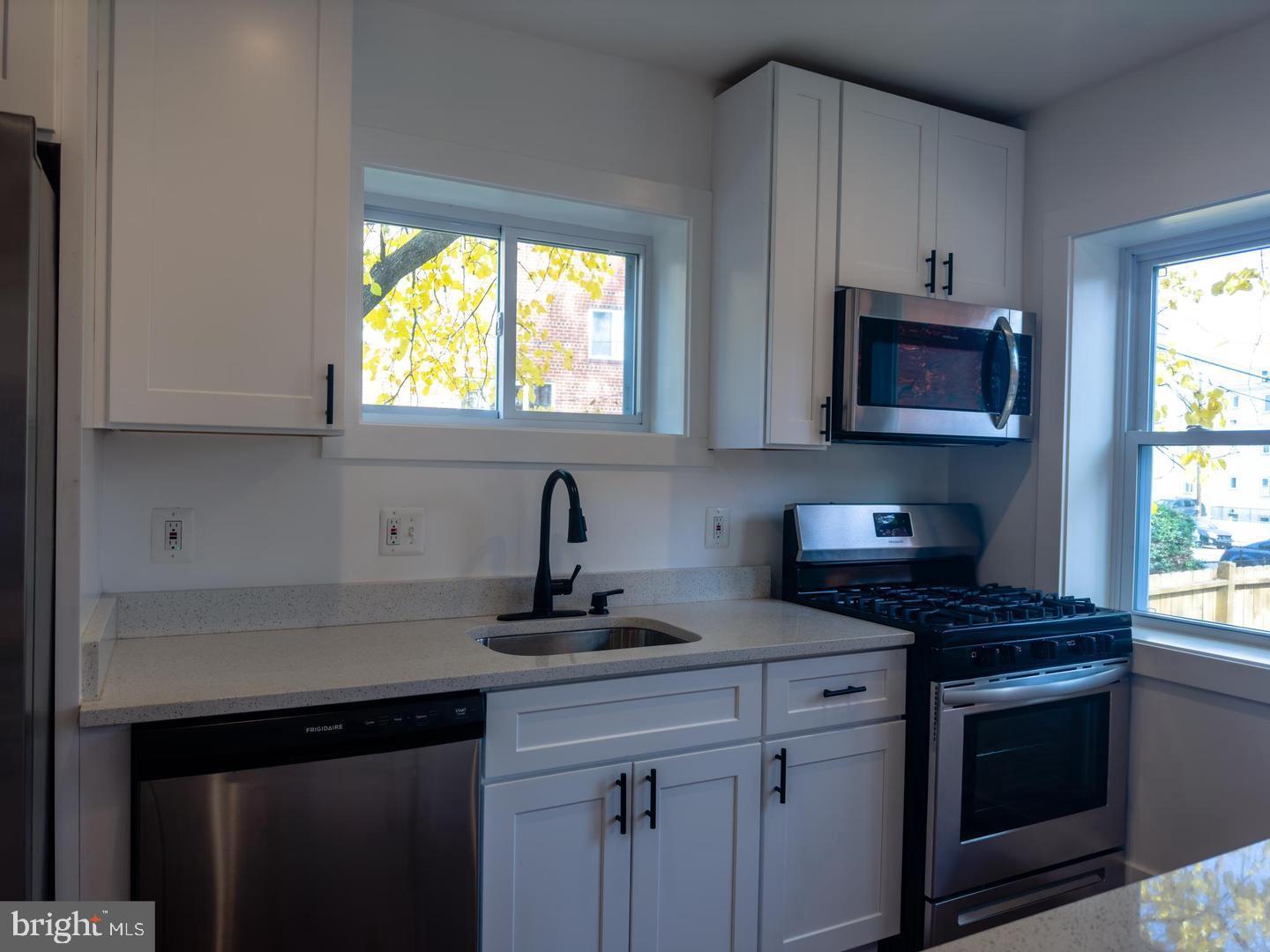 3326 12th Street Southeast Washington, DC 20032 - Photo 7 of 19 a kitchen with appliances a sink and a window