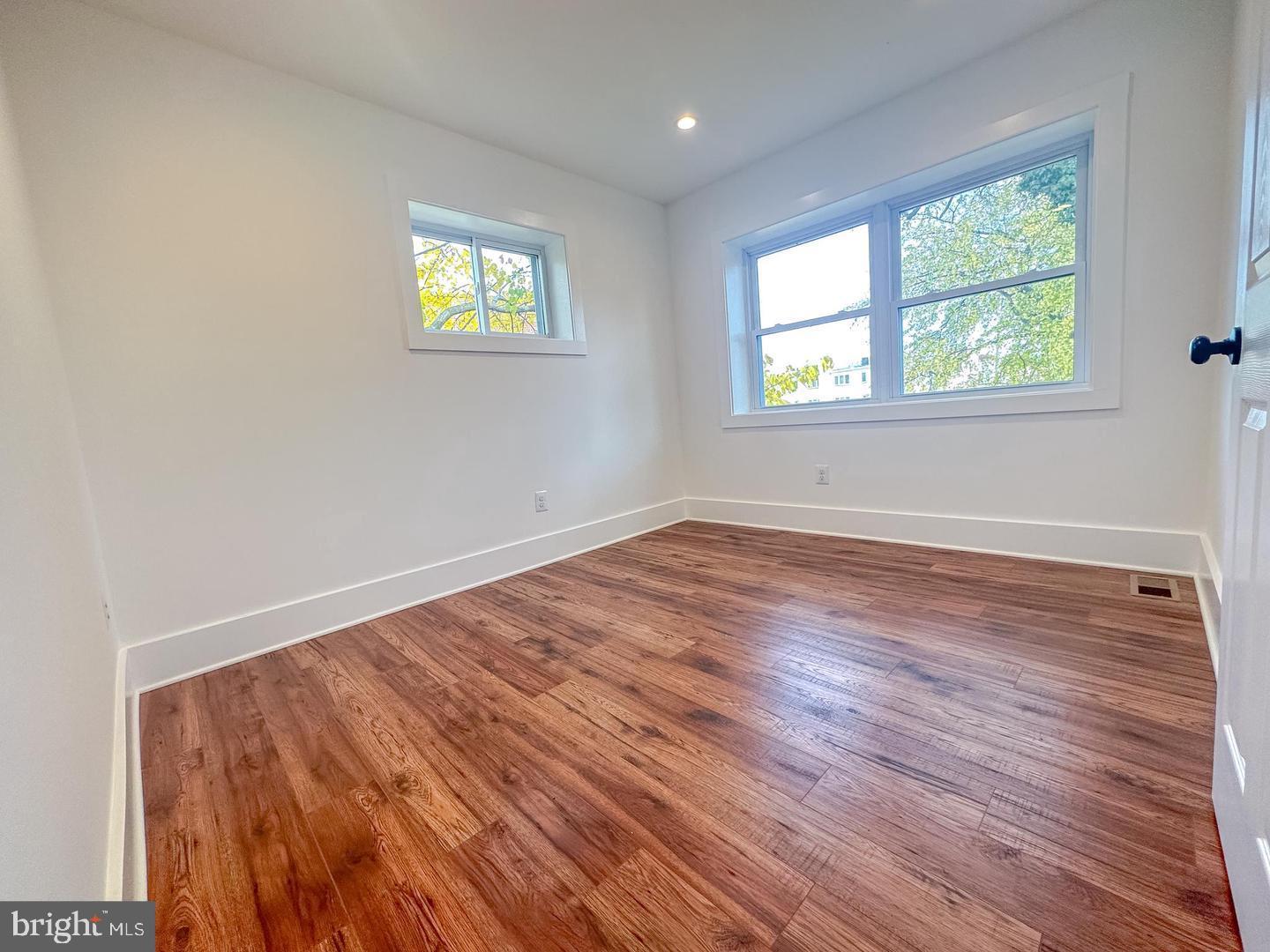 3326 12th Street Southeast Washington, DC 20032 - Photo 8 of 19 wooden floor in an empty room with a window