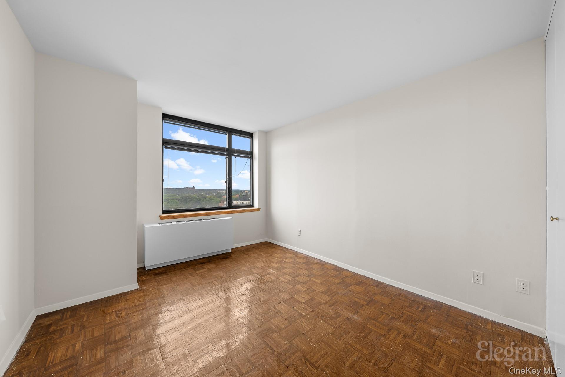 11201 Queens Boulevard, Unit 16F Queens, NY 11375 - Photo 11 of 24 a view of an empty room with a window