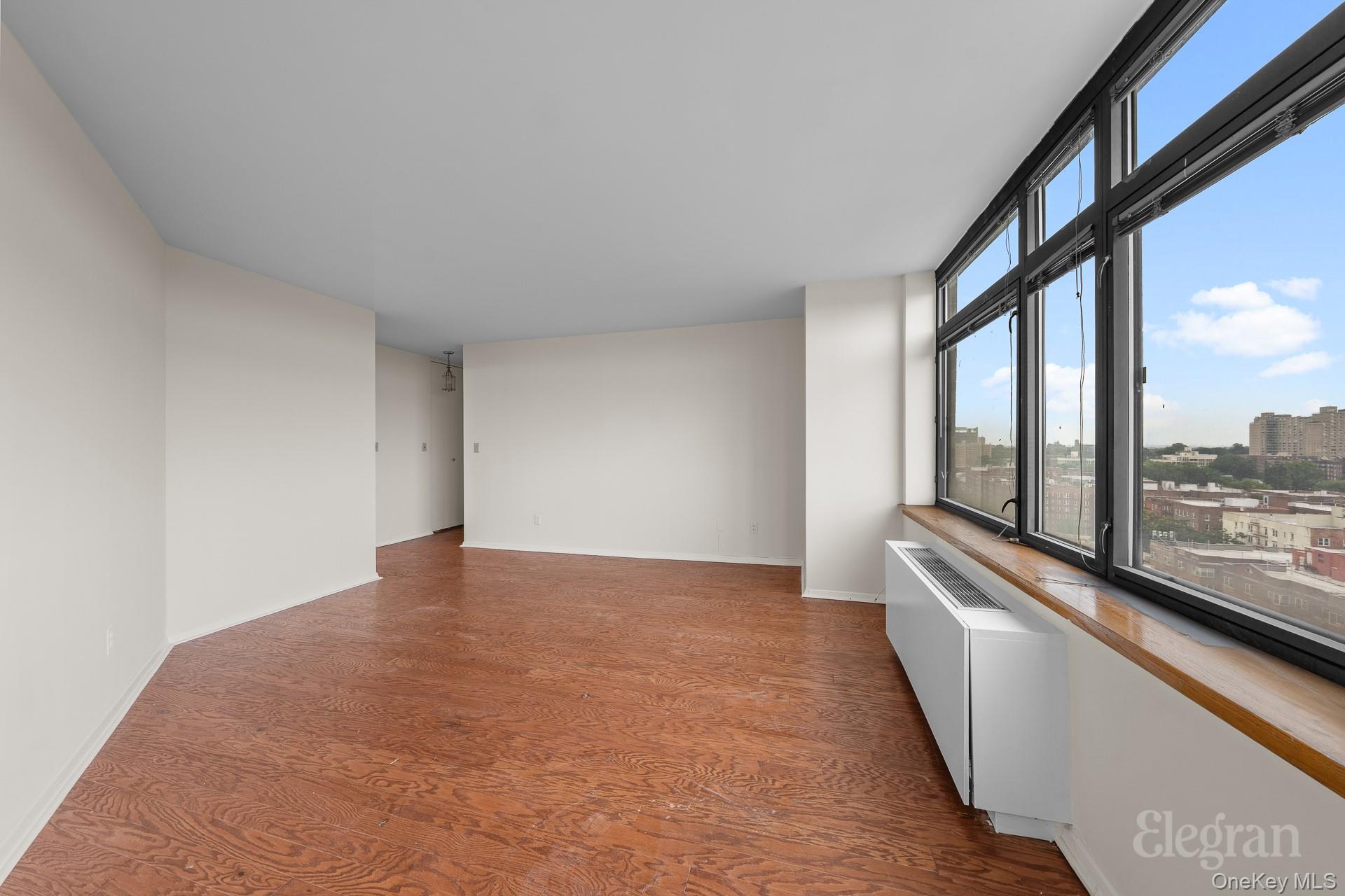 11201 Queens Boulevard, Unit 16F Queens, NY 11375 - Photo 7 of 24 a view of an empty room with a large window