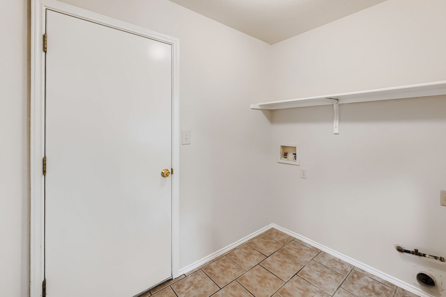 119 Stephen Lane Georgetown, TX 78626 - Photo 24 of 32 A laundry room awaits with convenient shelving and durable tiled flooring. Connects kitchen and garage.