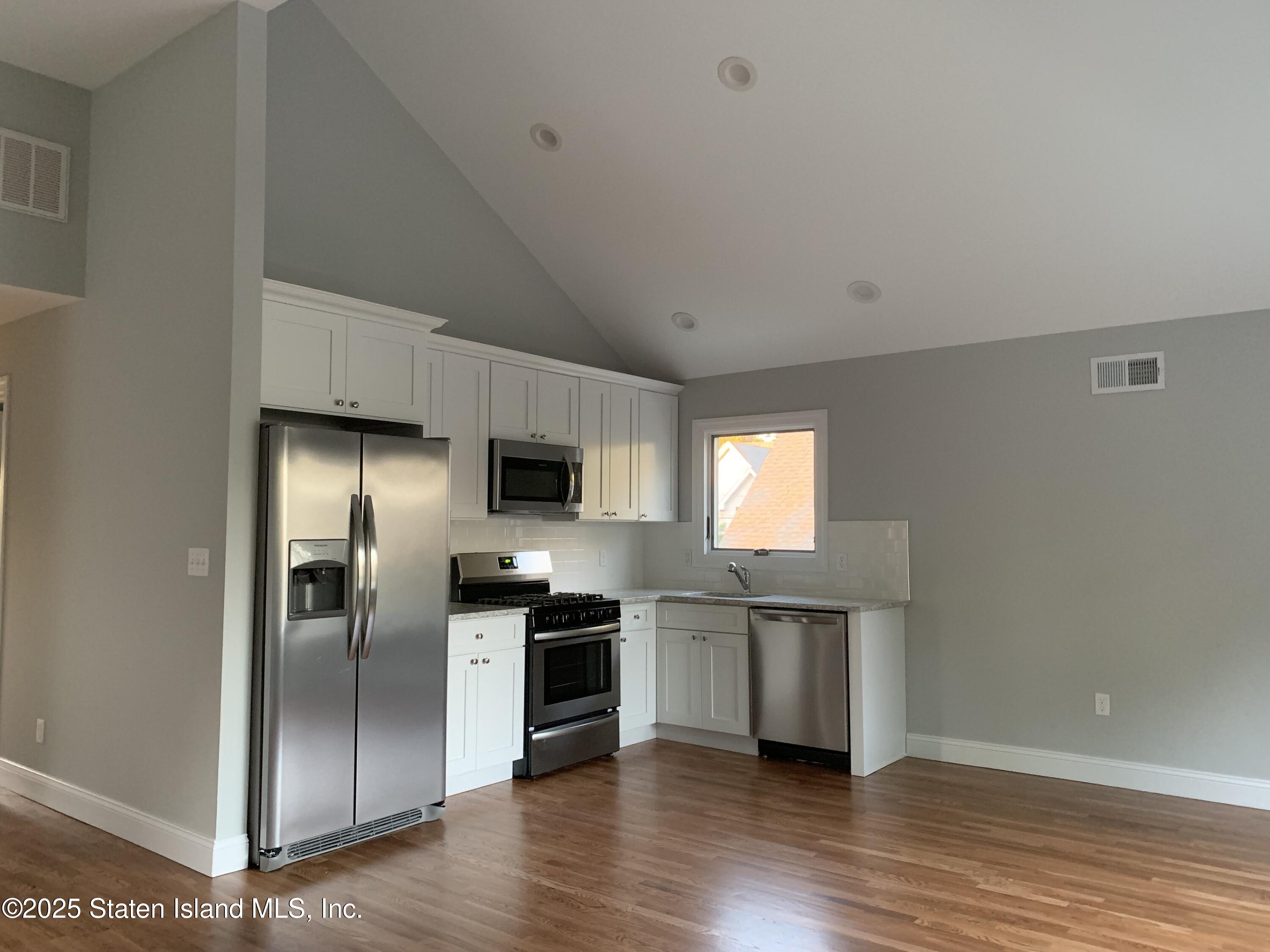 249 Purdy Avenue, Unit 2 Staten Island, NY 10314 - Photo 1 of 11 a kitchen with stainless steel appliances granite countertop a refrigerator a sink a stove and cabinets